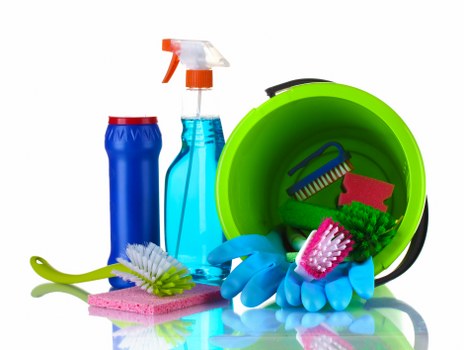 Cleaner preparing a safe cleaning area with protective equipment