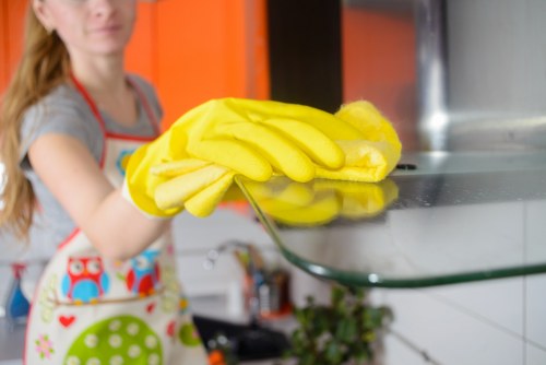 Cleaner following safe manual handling and workplace safety practices