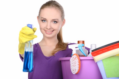 Professional cleaners sanitising desks in an Islington office